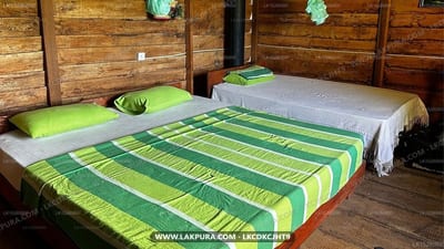 Sarilco Rock View Treehouse - wooden bedroom with three beds and striped green bedding