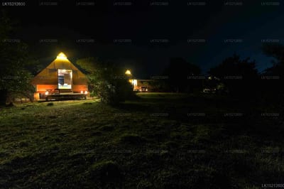 Kodev - glowing glamping tent in grassy field at night