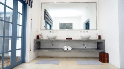 Apsara Villa - modern bathroom with dual sinks and large mirror