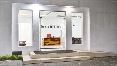 Emerald Hill Hotel - modern hotel entrance with glass doors and illuminated storefront