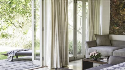 Elysium - modern living room with floor-to-ceiling windows and garden views