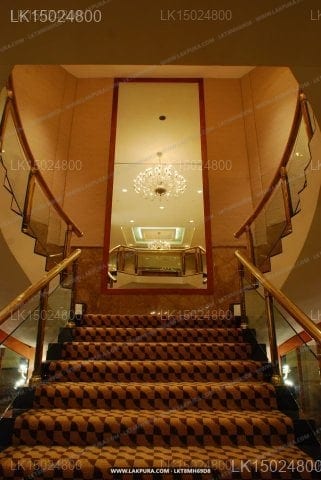 Ramada - grand staircase with patterned carpet and ornate handrails