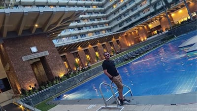 Cinnamon Trails - man on stationary bike overlooking hotel courtyard and pool