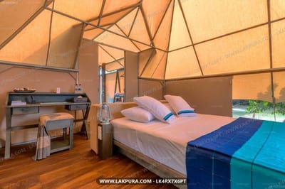 Kodev - glamping tent interior with bed, desk, and geometric canvas ceiling