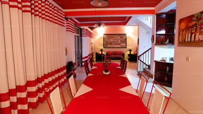 RedHill Kandy - red and white checkered corridor with red carpet and furniture