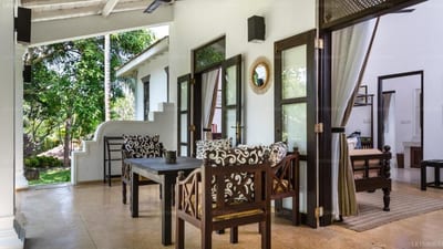 Why House - spacious colonial-style living room with wooden furniture and garden views