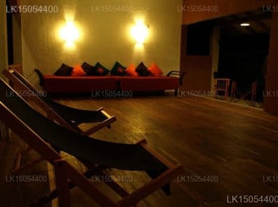 Wapi - wooden floor lounge with colorful cushioned seating and warm lighting