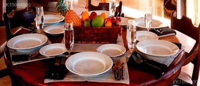 IF Villa - formal dining room table set for multiple guests with fruit centerpiece