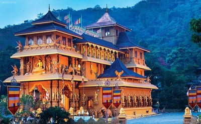 Grindlays Regency - ornate golden temple with multiple tiers set against forested mountains