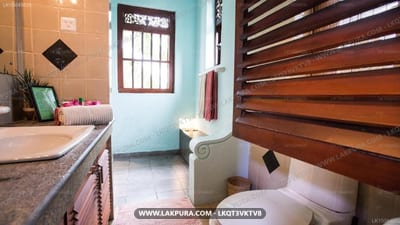 Max Wadiya - bathroom with vanity, toilet, wooden shutters and turquoise walls