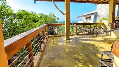 Villa Unique View - wooden deck with metal railings overlooking green landscape and houses