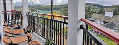 Misthill Rest - lounge chairs on balcony overlooking green hills and valley