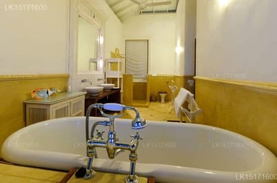 Beachfront Villa - vintage bathtub with yellow tile walls and sink