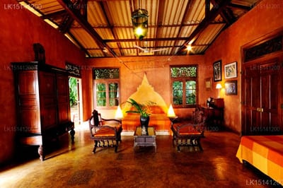 Java Moon - golden Buddha statue in warm-lit temple hall with red walls