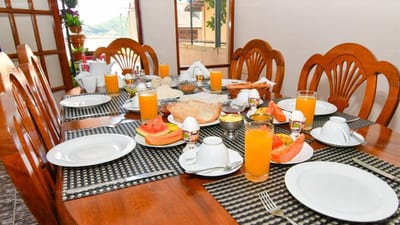 Expeditor - dining table set for breakfast with orange juice and pastries