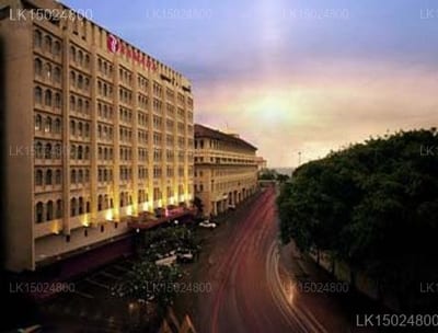 Ramada - lit apartment buildings overlooking curved street at dusk