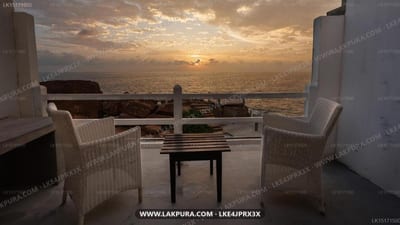 Sunset Point - two wicker chairs facing ocean sunset from elevated terrace