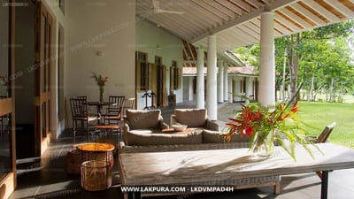Boundary House - covered veranda with wooden table, seating area and garden views