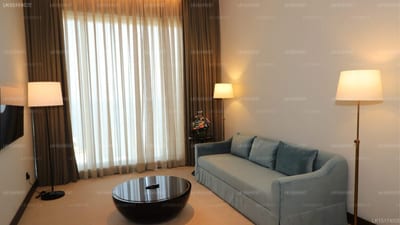 Sofia Colombo City Hotel - modern hotel suite with sofa, coffee table and large window