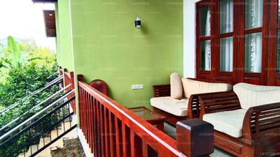 Moon Light - wooden seating area on balcony with green wall and garden view