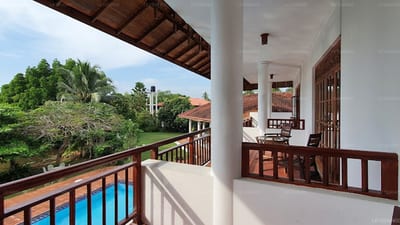 Bentota Waterside, Bentota - balcony overlooking swimming pool and tropical garden landscape