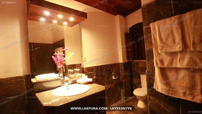 Villa Kusum - modern bathroom with lit mirror, dark tile walls, and heated towel rack