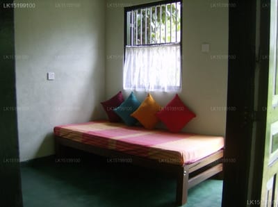 Sedevo Chalets, Kandy - bedroom with single bed, colorful pillows, and barred window