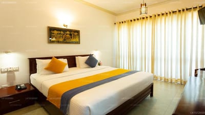 Hotel Yo, Kandy - spacious bedroom with yellow and grey bed runner, balcony doors