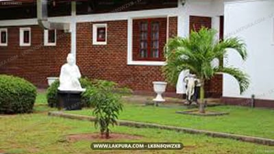 Hotel Chamila - brick building with manicured garden and decorative statues