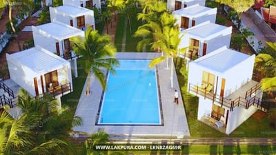 Arugambay Roccos - aerial view of swimming pool surrounded by white bungalows and palm trees