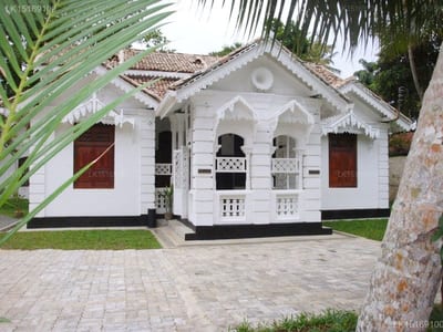 Singha Villa Regency - white colonial-style villa with ornate railings and palm trees