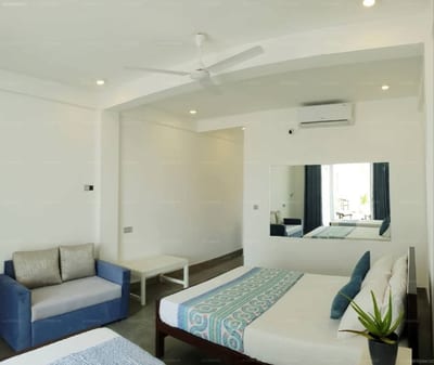 Hotel Blue Note - modern hotel room with double bed, blue sofa, and window