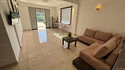 Rusty Bunk Villa, Kandy - spacious living area with brown sofa and tiled floors