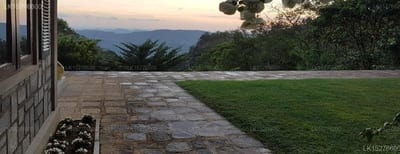 Benjamin Cottage - stone pathway beside manicured lawn with mountain views at dusk