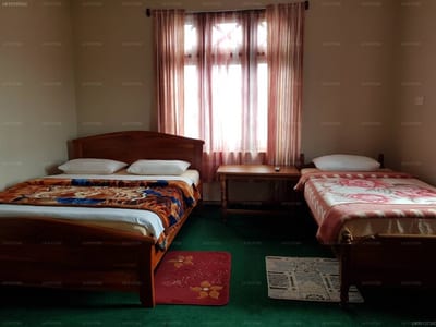 Carnation Rest - twin bedroom with wooden beds and burgundy curtains