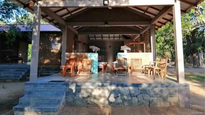 Hide Yala - covered outdoor dining area with wooden furniture and shade structure