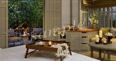 Hit Camp - indoor lounge area with wooden furniture and lit candles at dusk