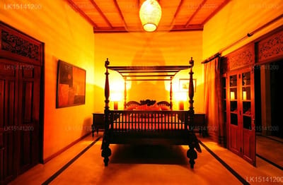 Java Moon - bedroom with four-poster bed and warm orange lighting