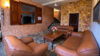 Sunset Point - warm-toned lounge with leather seating and stone walls