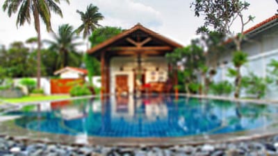 Bethany 101 - blue pool with wooden gazebo surrounded by tropical gardens