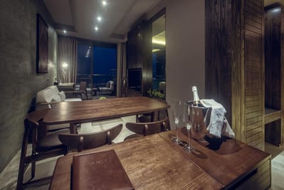 Pledge Scape - modern office workspace with wooden desks and nighttime city views