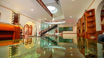 Wisdom Boutique Resort - wooden furniture showroom with polished floor and staircase
