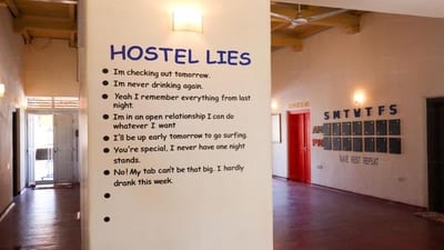 Why Not Backpackers - hostel rules wall with checklist of house guidelines painted in blue text