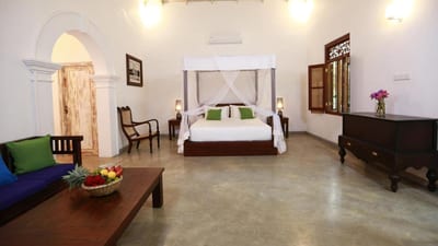 Ceylon Olive - spacious bedroom with four-poster bed, seating area, and traditional furnishings