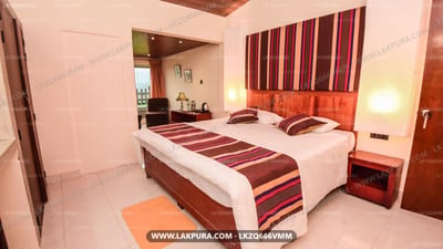 Iris Villa - two double beds with burgundy striped runners in warm-toned bedroom