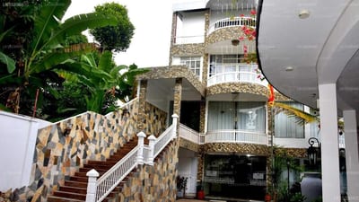 Grand Regency Hotel - stairway with patterned stone wall leading to multi-story building entrance