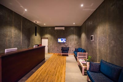 Ballena Regency - modern hotel lobby with wooden flooring and dark textured walls