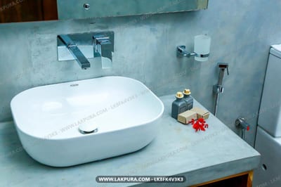 Doola River Edge - white oval basin sink with modern chrome fixtures and gray countertop