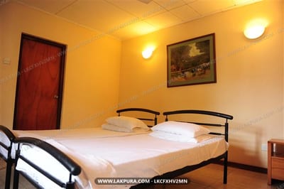 Secure Villa - bedroom with double bed, red door and warm lighting