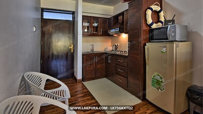 Mariners Cabin - kitchenette with dark wood cabinets and stainless steel appliances